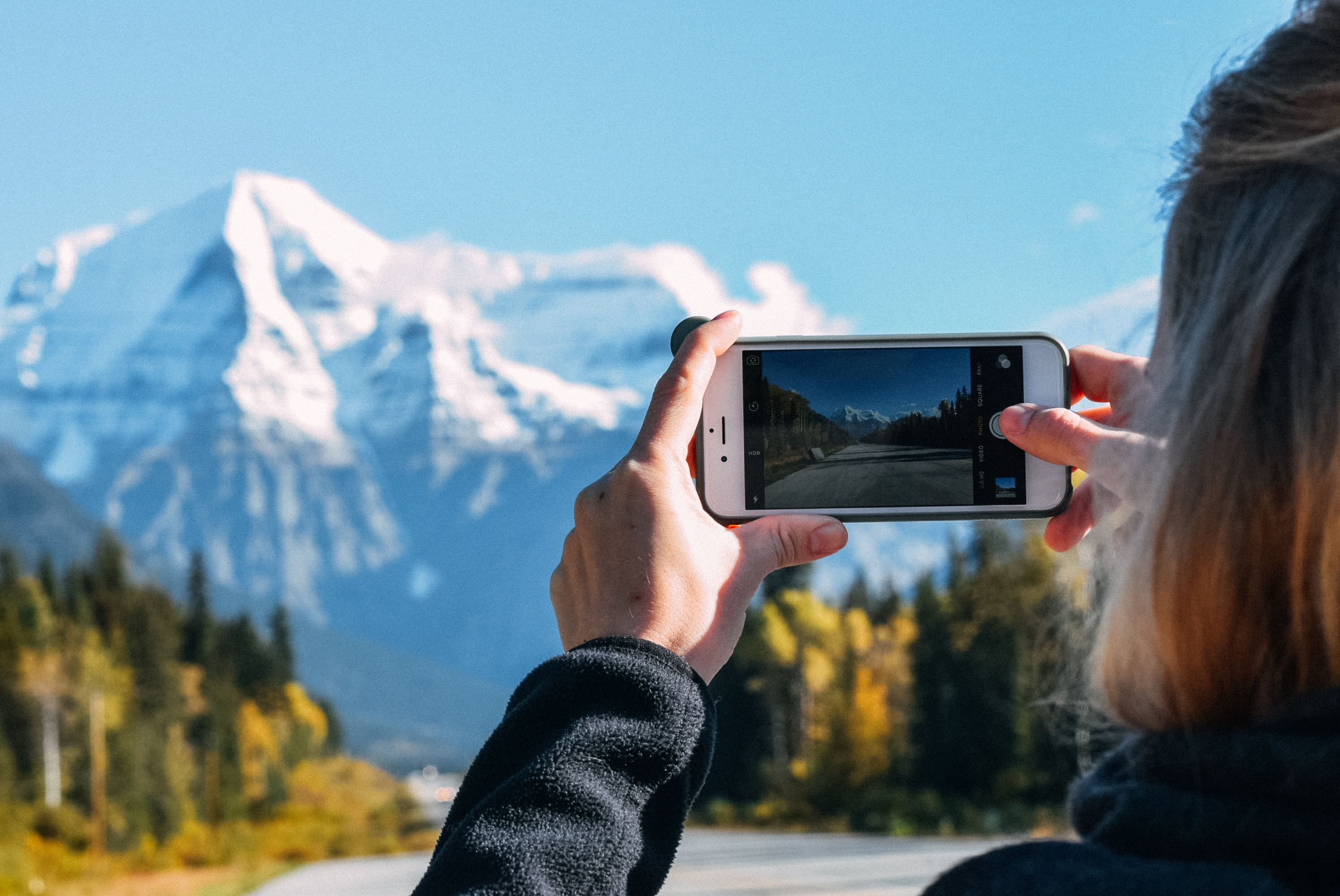 Person with iPhone in mountains